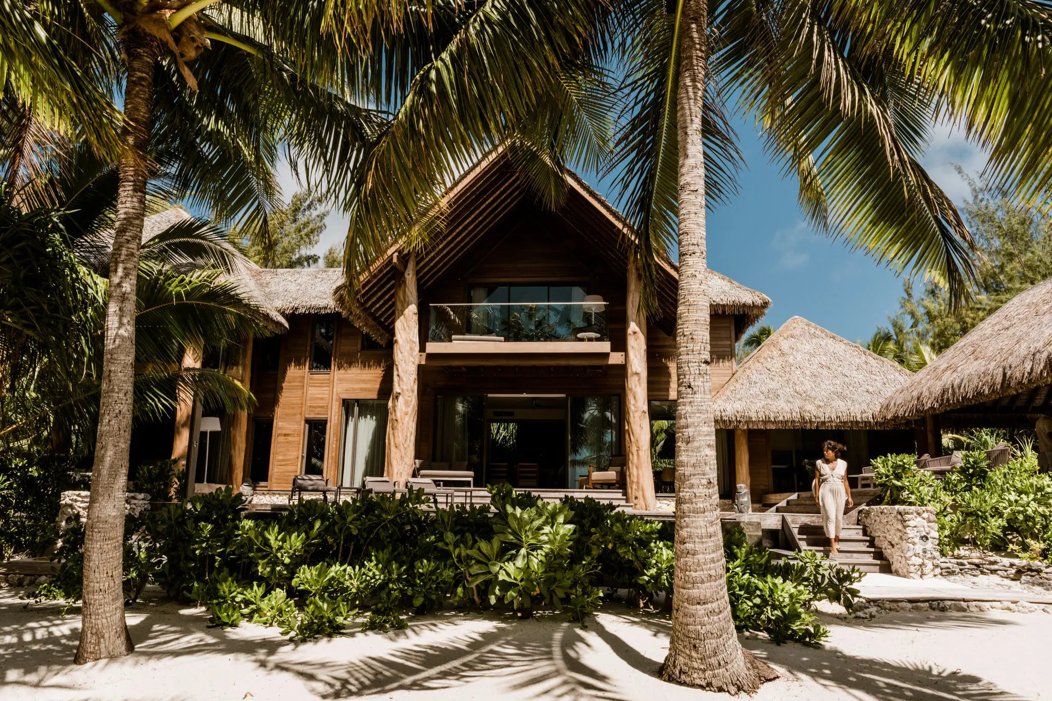 Private beachfront villa at The Brando with open balcony, shaded deck, and lush palm surroundings—designed for discreet luxury and seclusion.