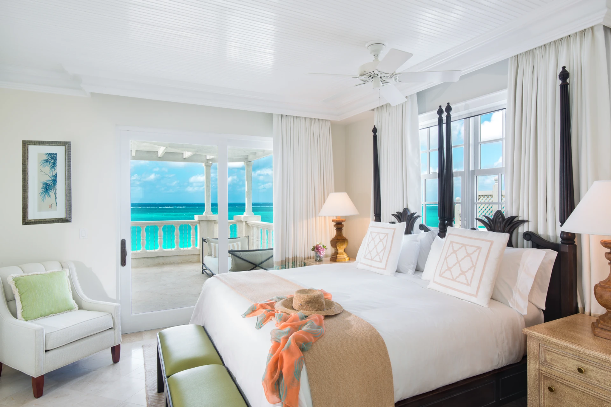 Luxury oceanview suite at The Palms Turks and Caicos with four-poster bed and private balcony