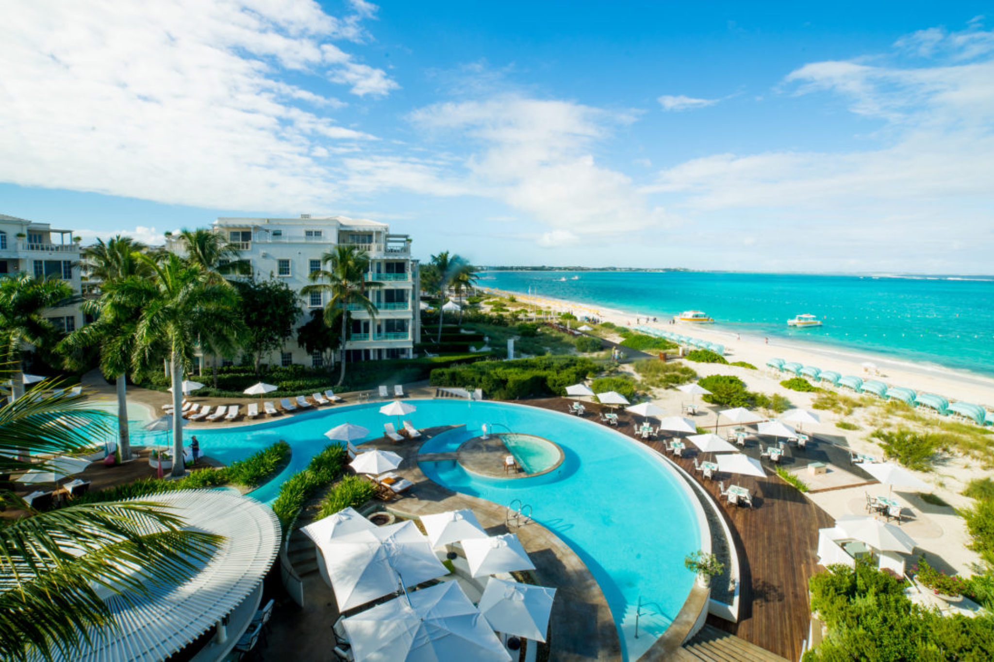 Aerial view of The Palms Turks and Caicos pool and beachfront on Grace Bay
