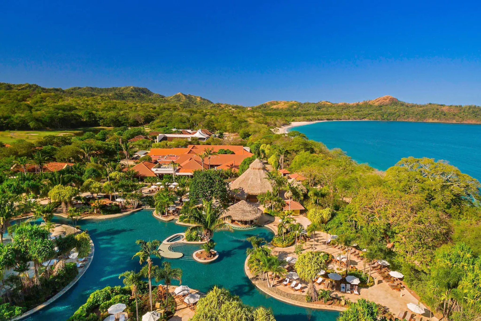 Aerial view of The Westin Reserva Conchal resort nestled between lush rainforest and the Pacific coast of Costa Rica.