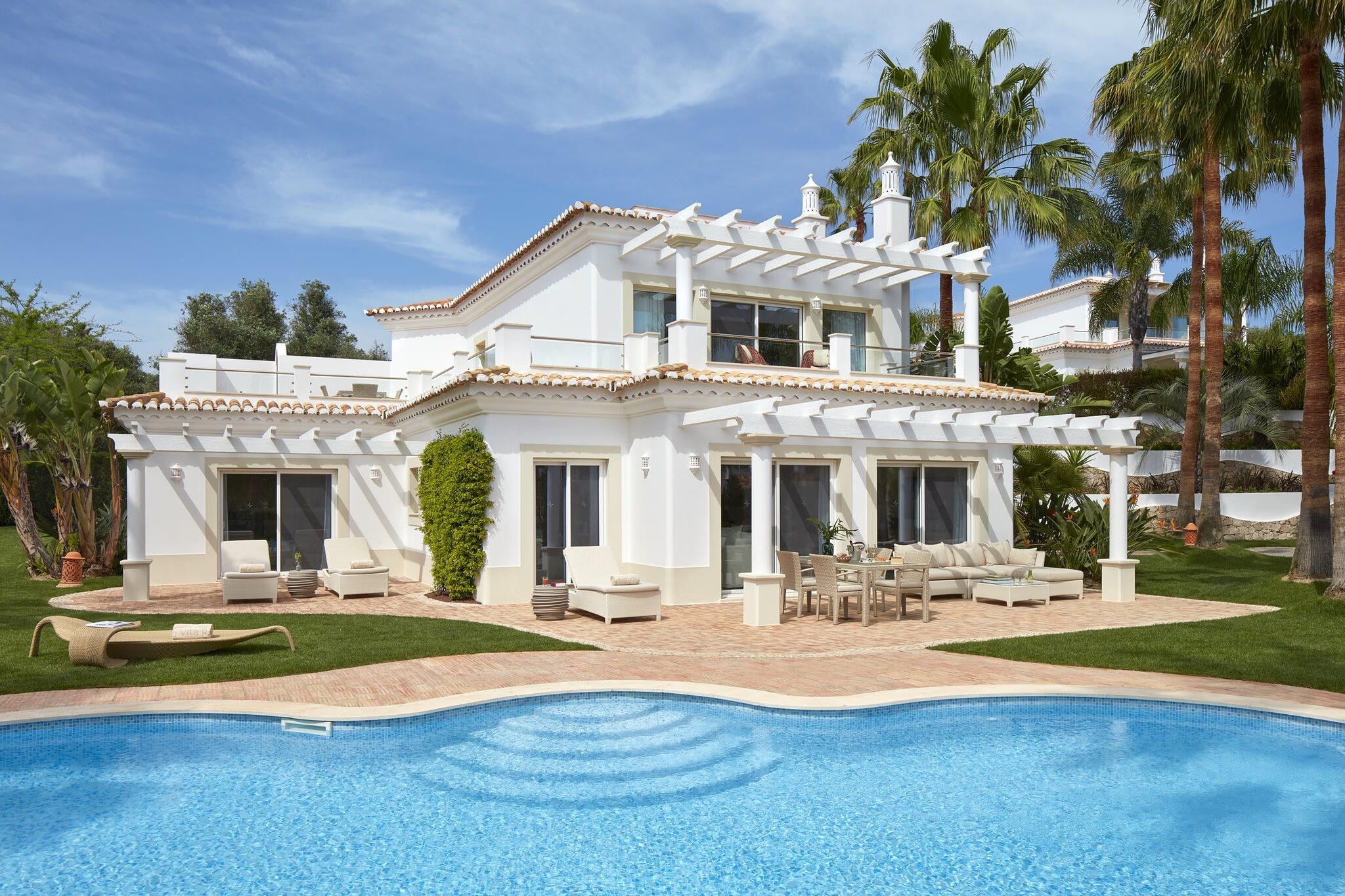 A whitewashed Algarve villa at Vila Vita Parc overlooking landscaped gardens and a sparkling private pool, showcasing Portuguese coastal luxury that secures its place as one of the top beach resorts in Europe in 2025.