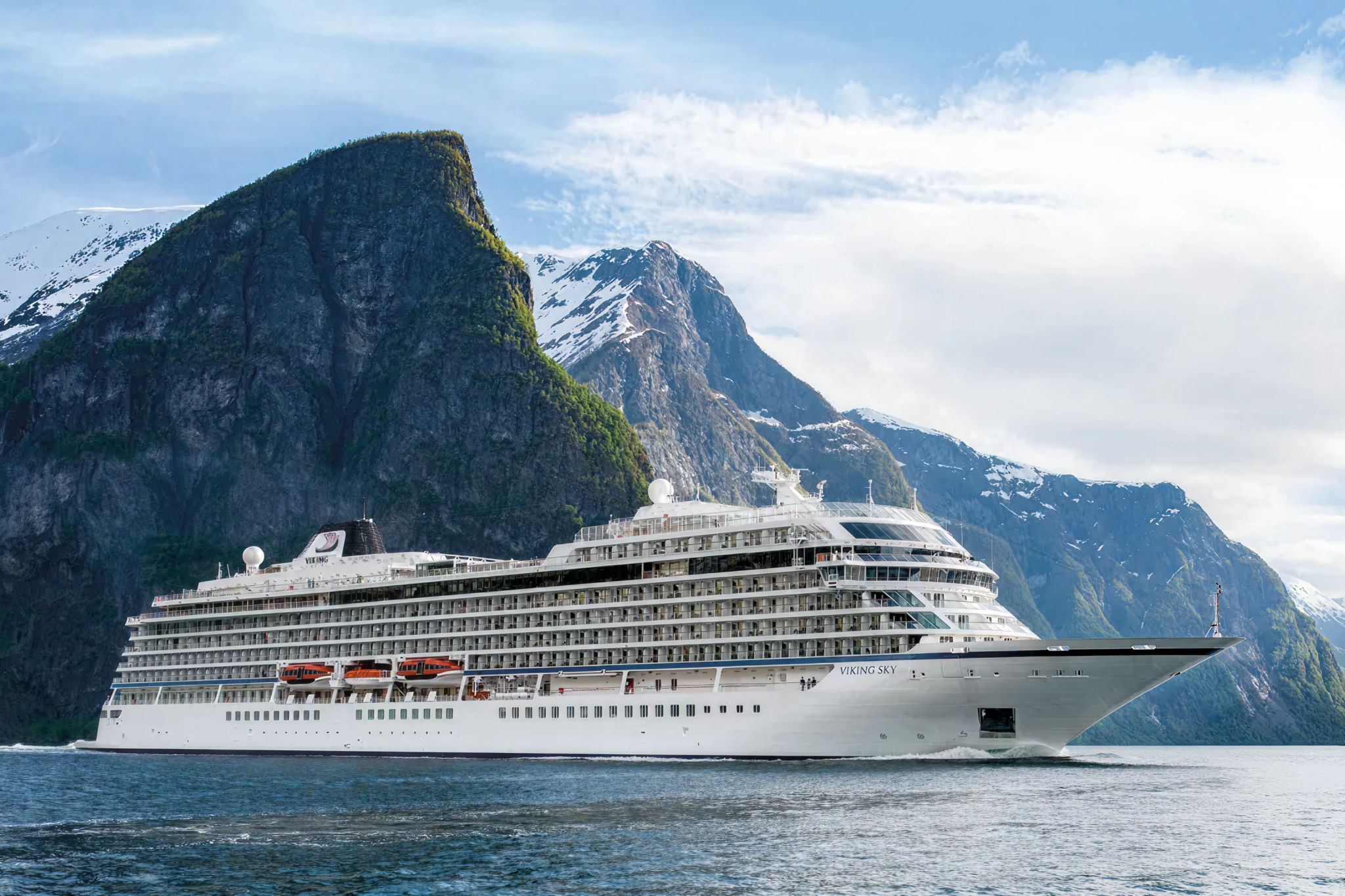 Viking ocean ship cruising through Norwegian fjords—offering some of the best cruises for elderly travelers who enjoy scenic, peaceful exploration.