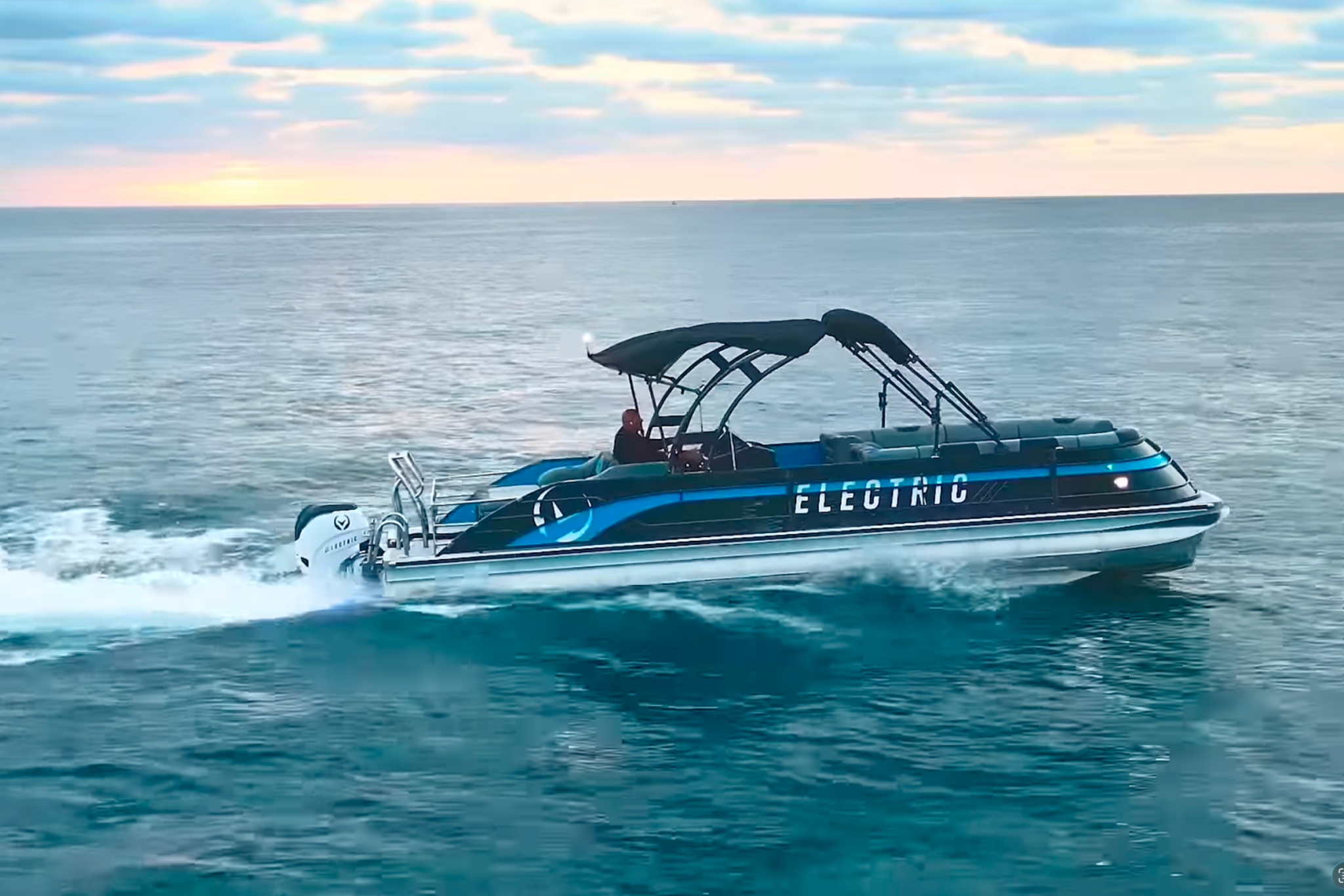 A top-down view of the V30 Electric Pontoon interior layout, showing wraparound seating, helm position, open deck flow, and space designed for larger groups.