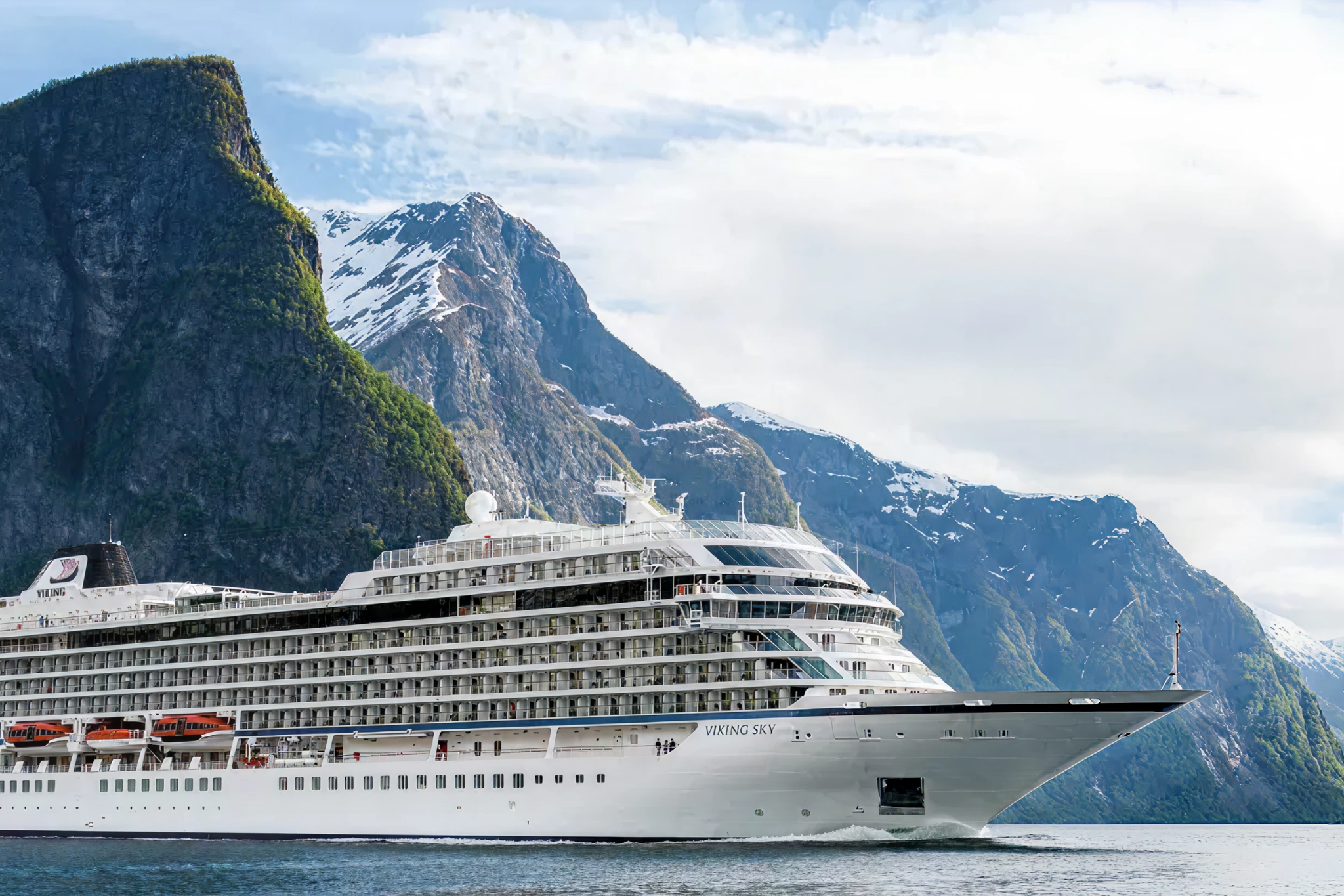 Viking Libra small-ship cruise sailing through a dramatic fjord, highlighting Viking’s hydrogen-powered, environmentally focused ocean ship