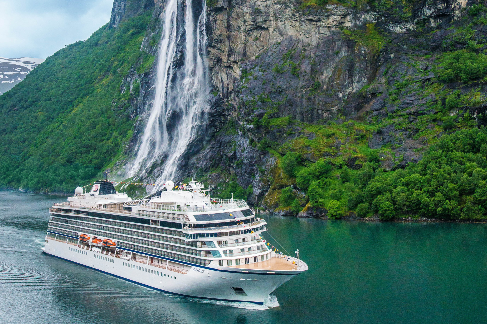 Viking Mira small-ship cruise sailing through a dramatic fjord landscape, highlighting Viking’s intimate ocean ship design