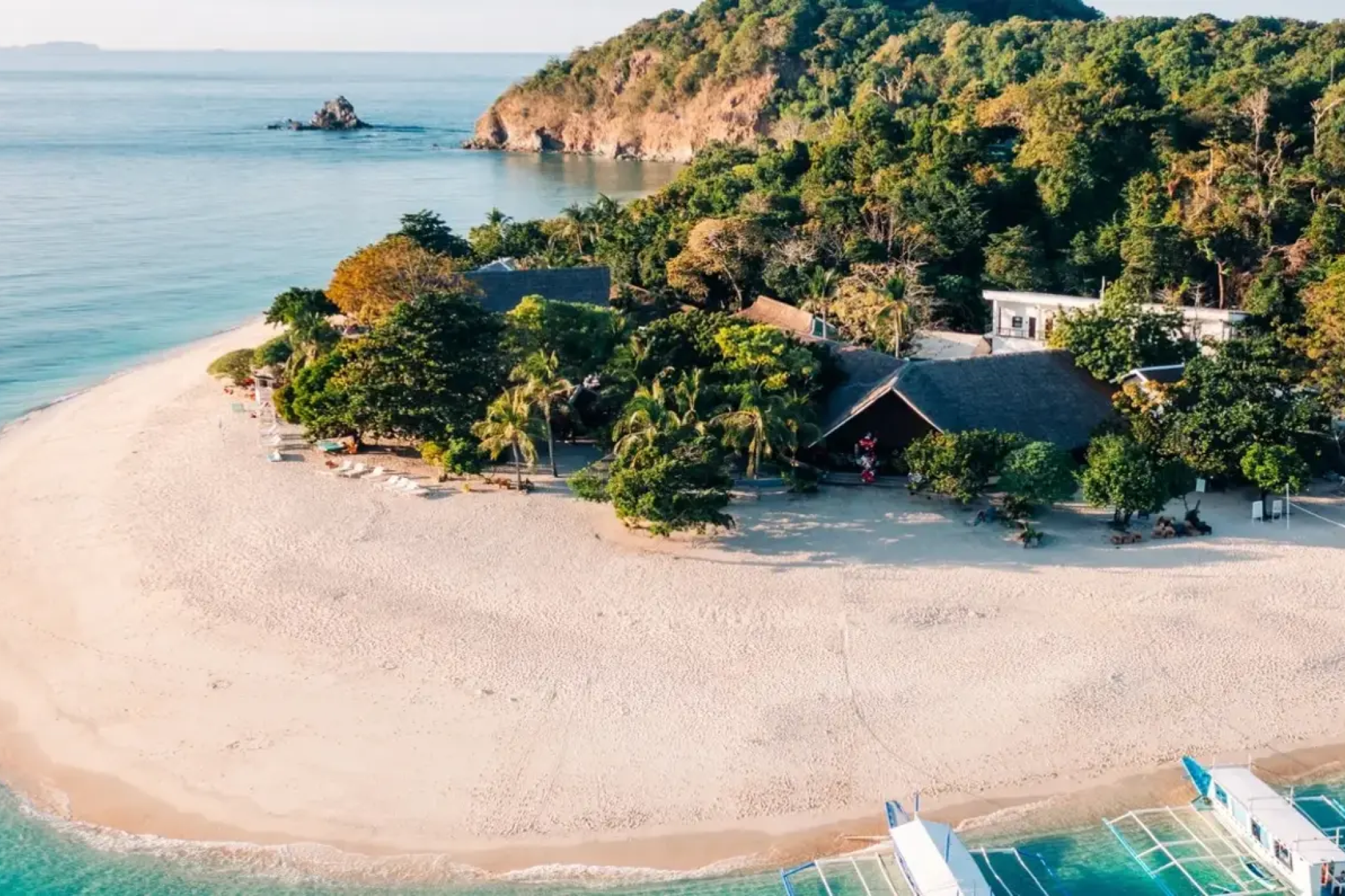 Aerial view of Club Paradise Palawan on Dimakya Island, surrounded by white sand and turquoise water — a private island retreat perfect for those exploring Where to Stay in Coron.