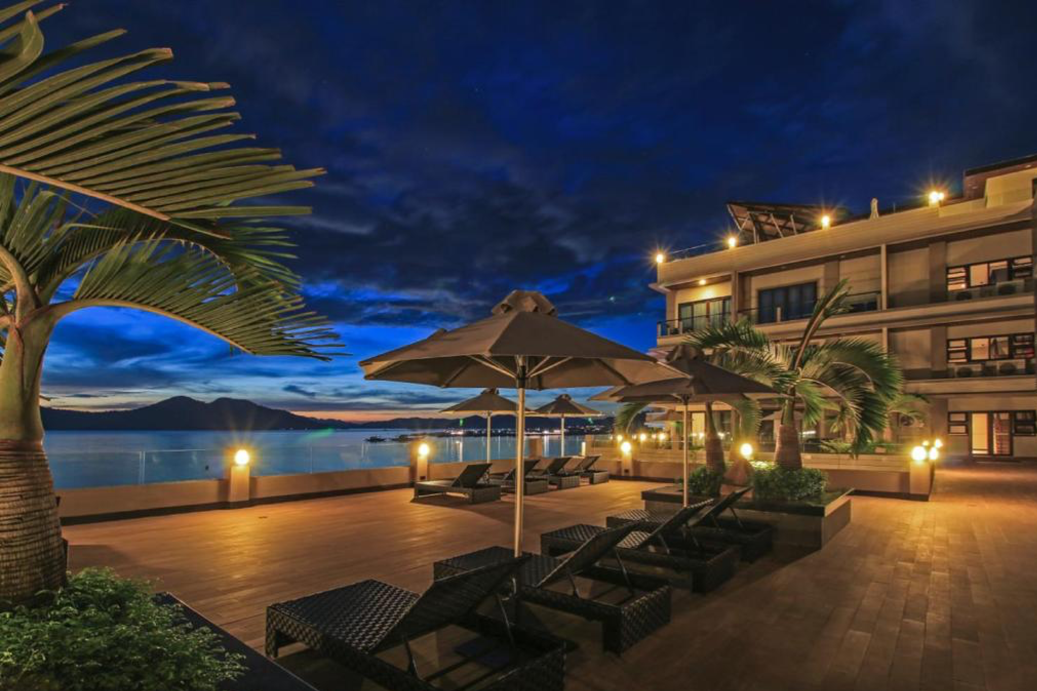 Two Seasons Coron Bayside Hotel at sunset, featuring a scenic infinity deck overlooking Coron Bay — a top choice for Where to Stay in Coron for bayside elegance.