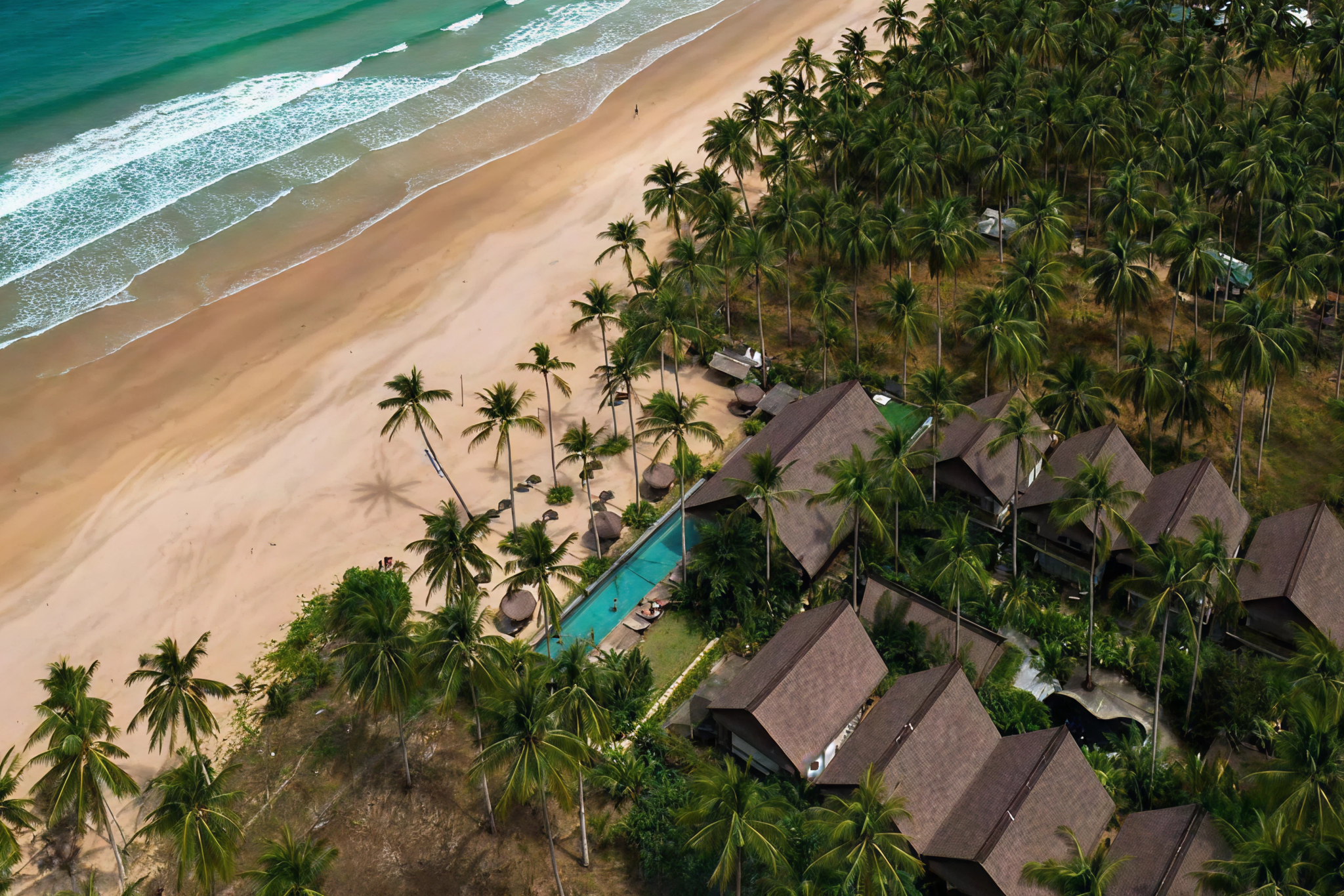 Luxury beachfront resort with palm-fringed pool along Nacpan Beach — where to stay in El Nido, Palawan.