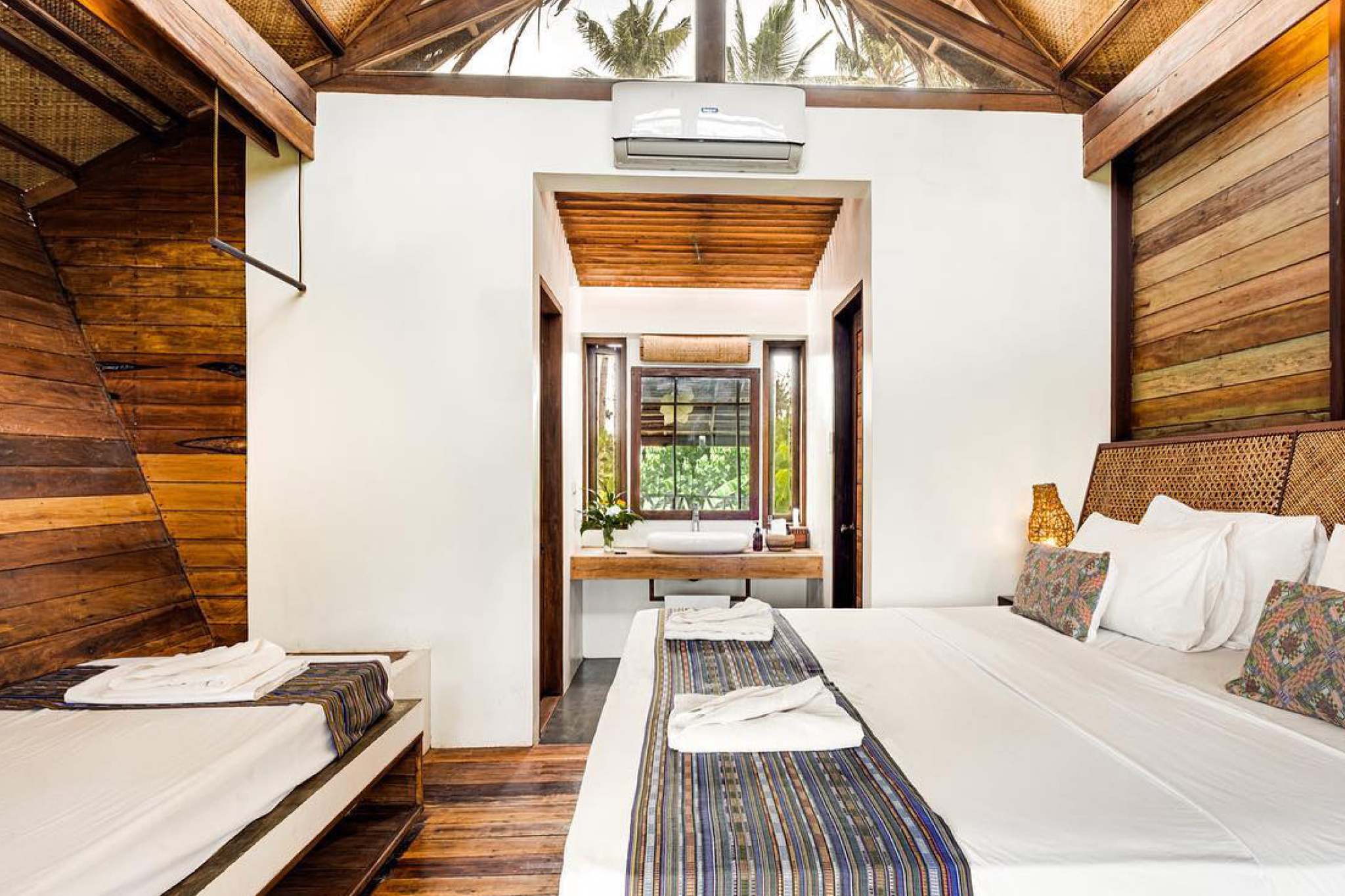 Tropical wood-accented villa room with natural textures — Harana Surf Resort, Where to Stay in Siargao.
