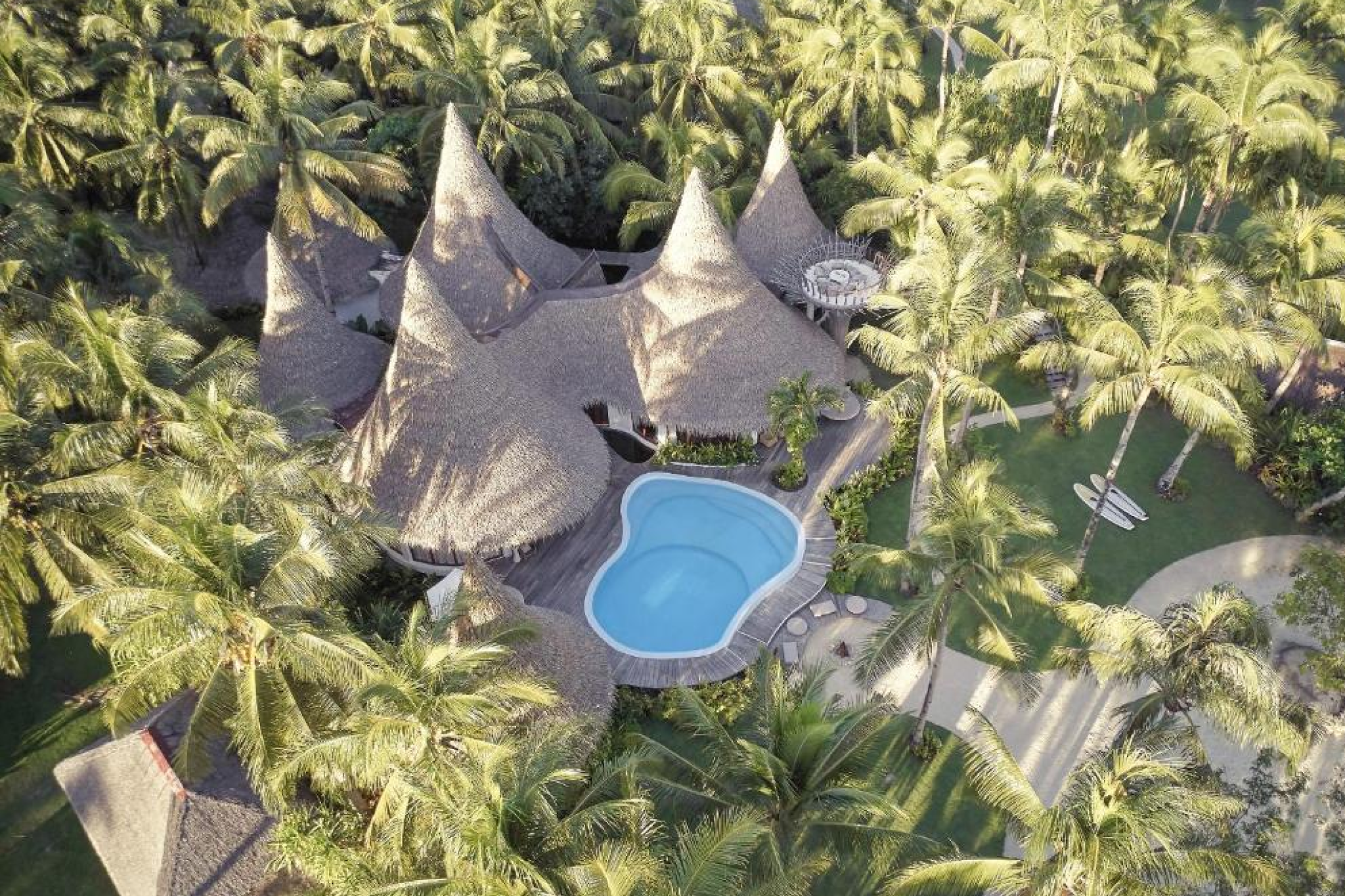 Aerial view of Nay Palad Hideaway’s thatched villas and pool — Where to Stay in Siargao.