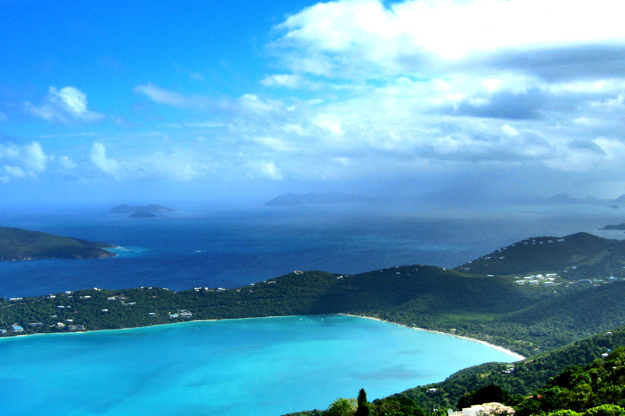 Cluster of green islands with rocky shorelines and surrounding clear blue ocean, part of a portfolio of billionaire islands owned by Larry Page across the Caribbean and Pacific.